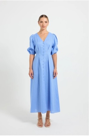 Woman wearing blue dress and jacket