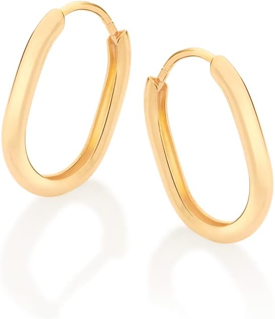 Gold hoop earrings on white background